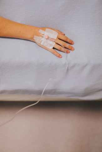 intravenous hose on person s hand